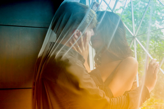 closeup-of-young-loving-couple-kissing-on-the-floor_35666-70